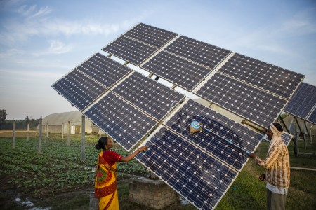 Farmers clean the solar panels for better efficiency