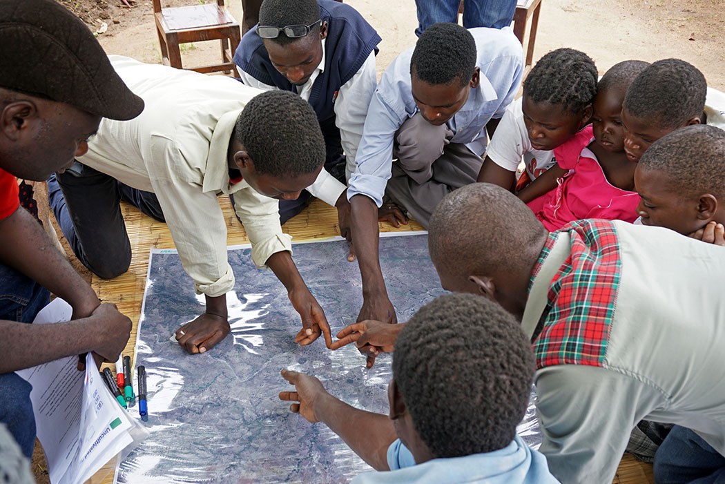 Youth in Malawi discuss their water resources before mapping them.