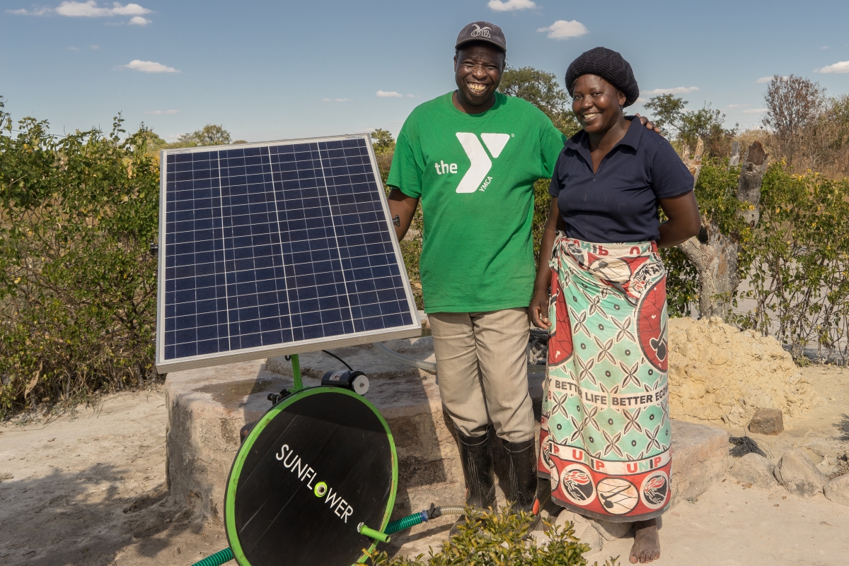 Kenyan farmers posing with a solar irrigation pump. Kenyan farmers posing with a solar irrigation pump.