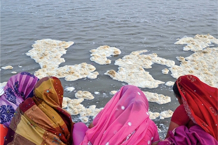 Women worship on polluted bank of the Ganges, in Allahabad, India.