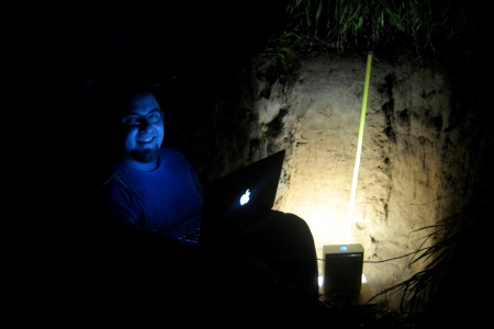 Daniel Hirmas, a professor at University of Kansas, uses the MLT scanner at night in a soil pit.  