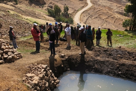 A presentation made at the workshop shows the stark difference in landscapes in Ethiopia – (L) without interventions and (R) with sustainable intensification.