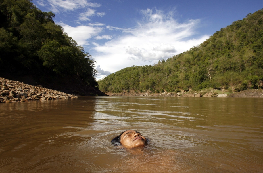 A 16-year-old Karen boy swims in the Salween River at the Myanmar-Thai border. A 16-year-old Karen boy swims in the Salween River at the Myanmar-Thai border.