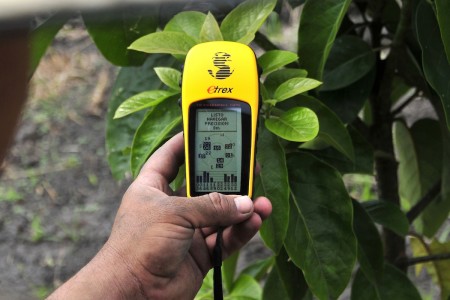 A handheld GPS device is used to collect information on planting decisions of hundreds of farmers in Colombia to help them make the best choices.